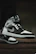 Close-up of trendy sneakers on a city sidewalk, highlighting clean design and premium materials.