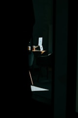 Soft morning light over a desk with a laptop and coffee.