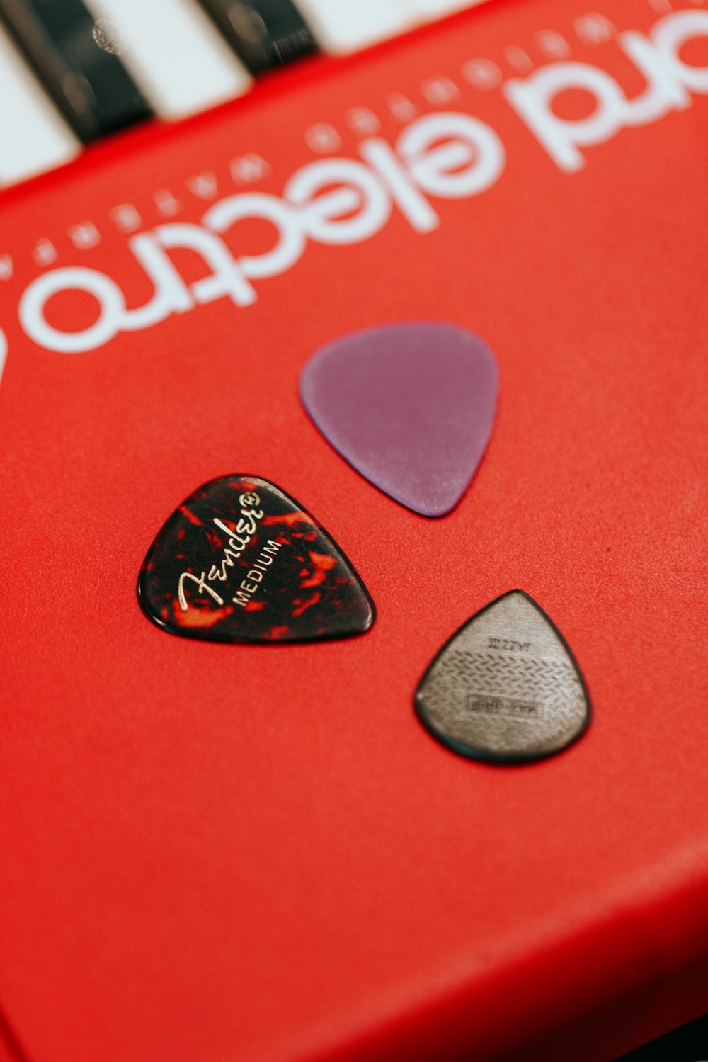 a close up of a red guitar picker