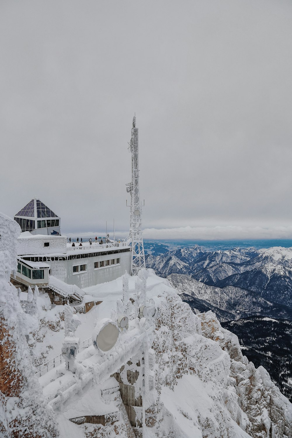 a building on top of a mountain covered in snow