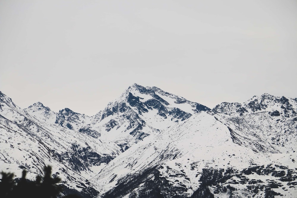 a mountain range covered in snow in the winter