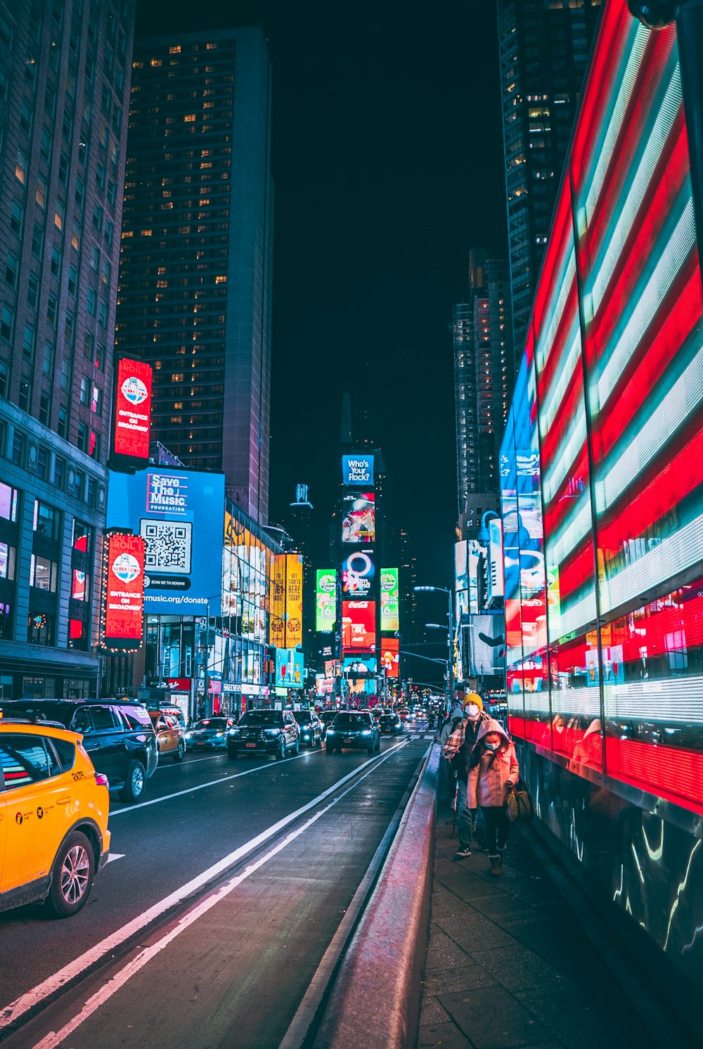 a city street filled with traffic and tall buildings