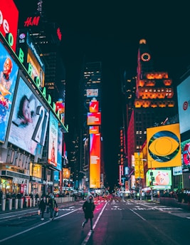 a busy city street at night with neon signs