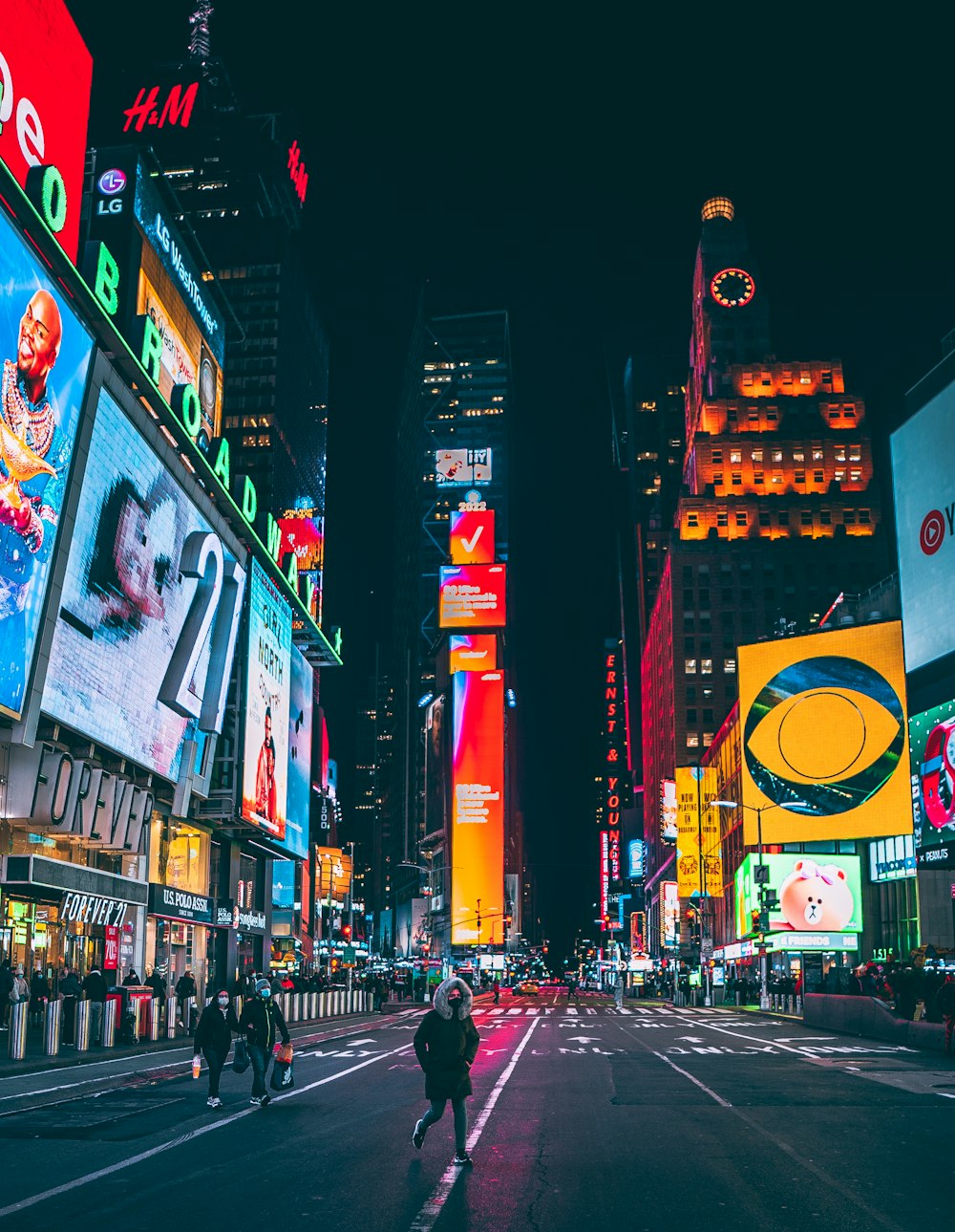 a busy city street at night with neon signs