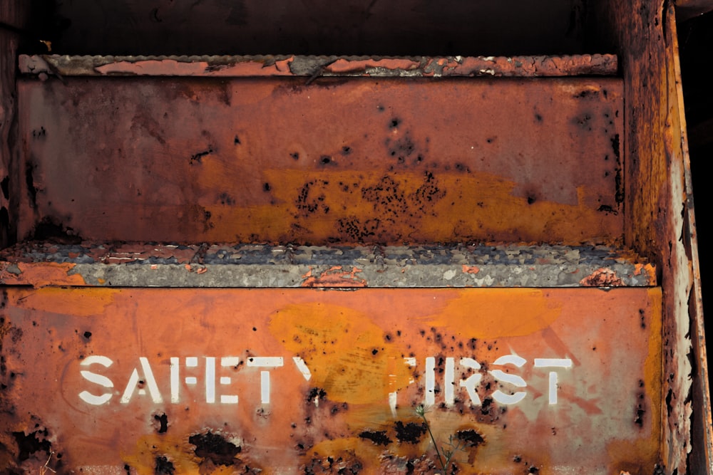 a rusted metal box with writing on it