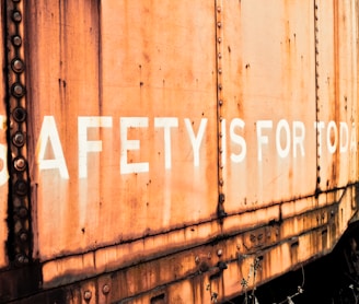 a rusted train car with the words safety is for all