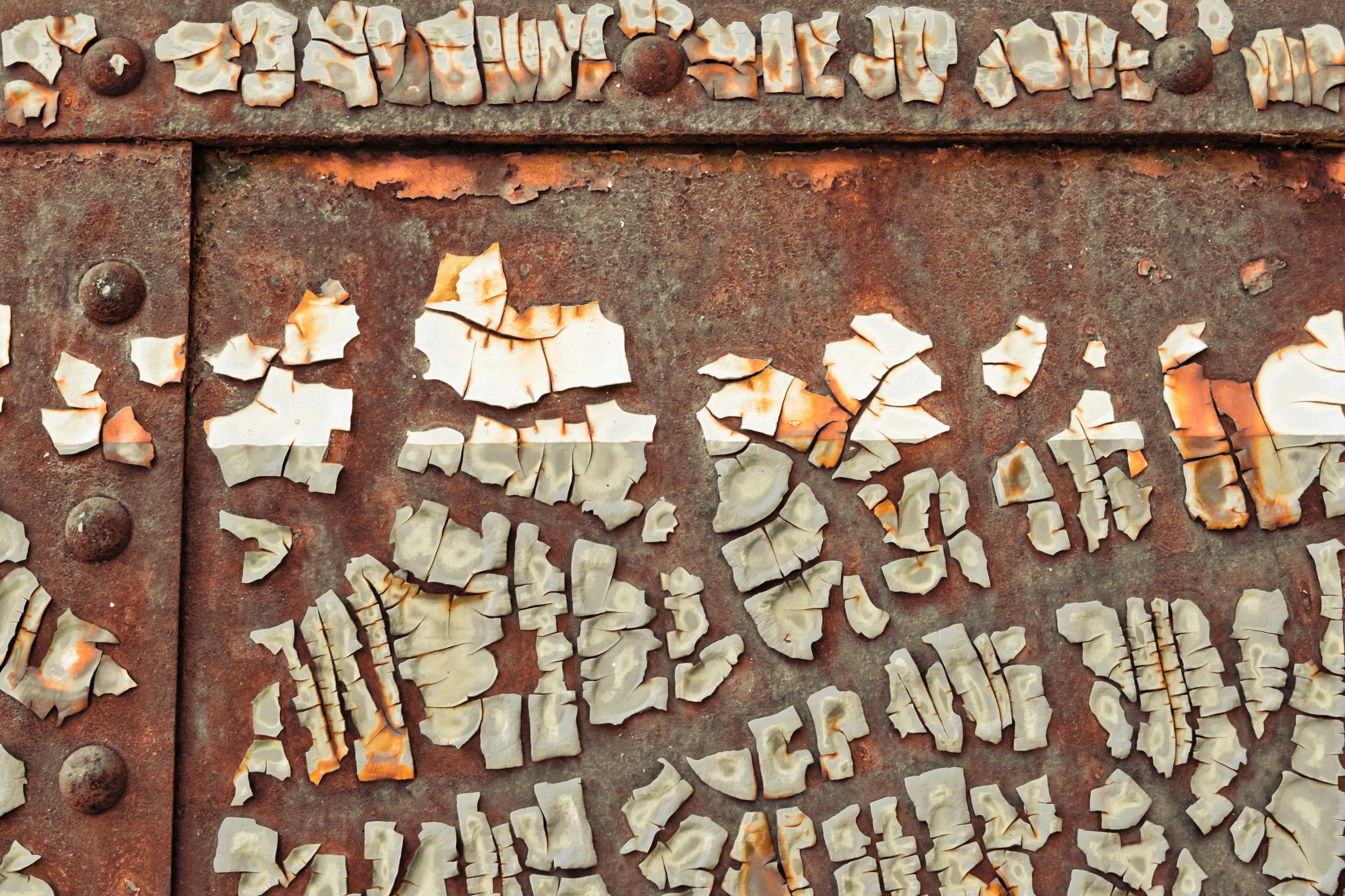a rusted metal surface with letters and numbers on it