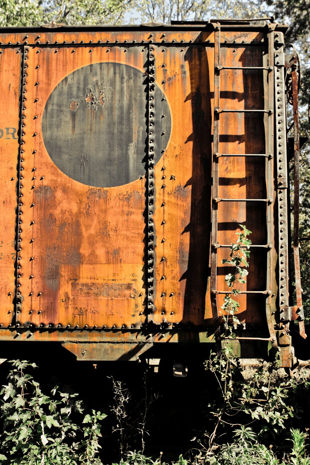 an old rusted train car sitting in the woods