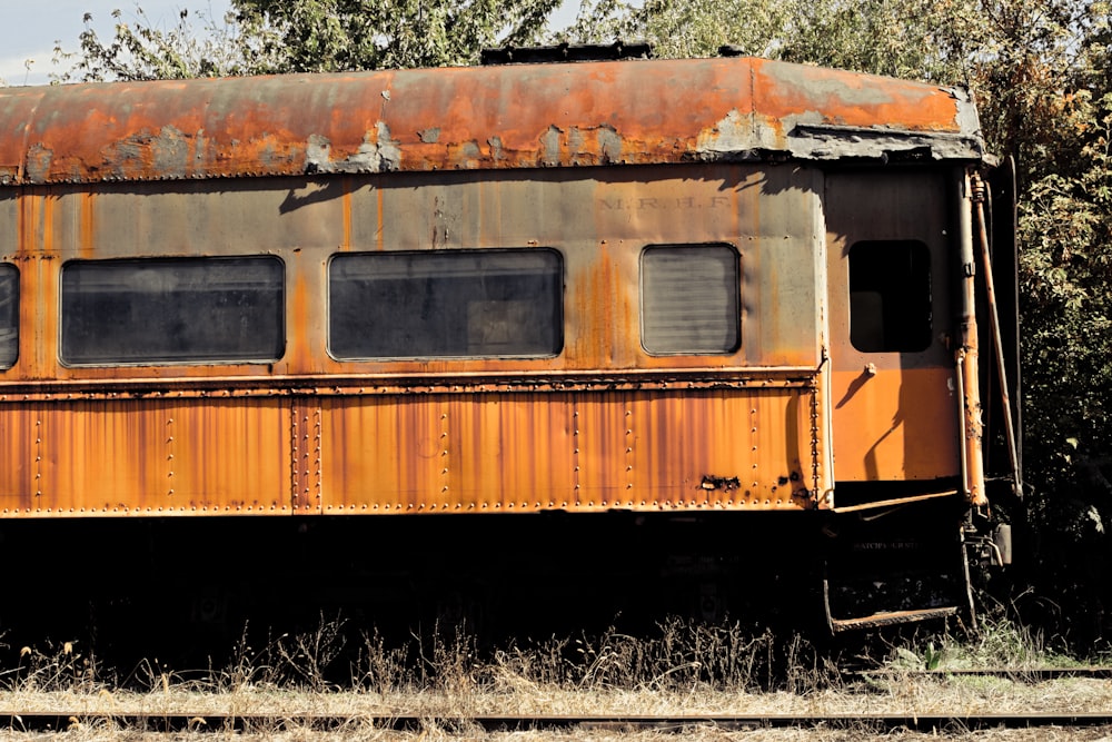 an old rusty train car sitting in a field