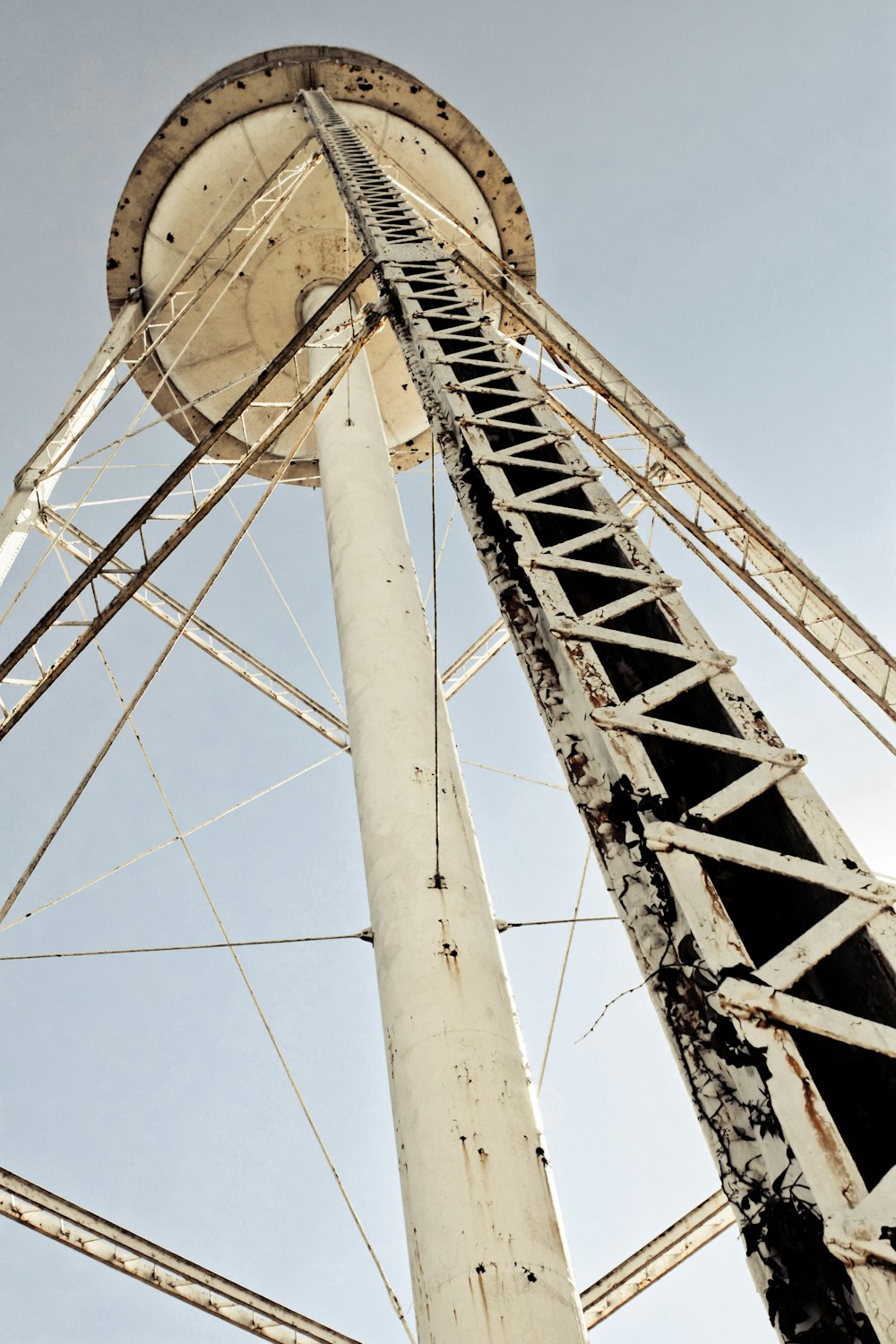 an old water tower with a sky background