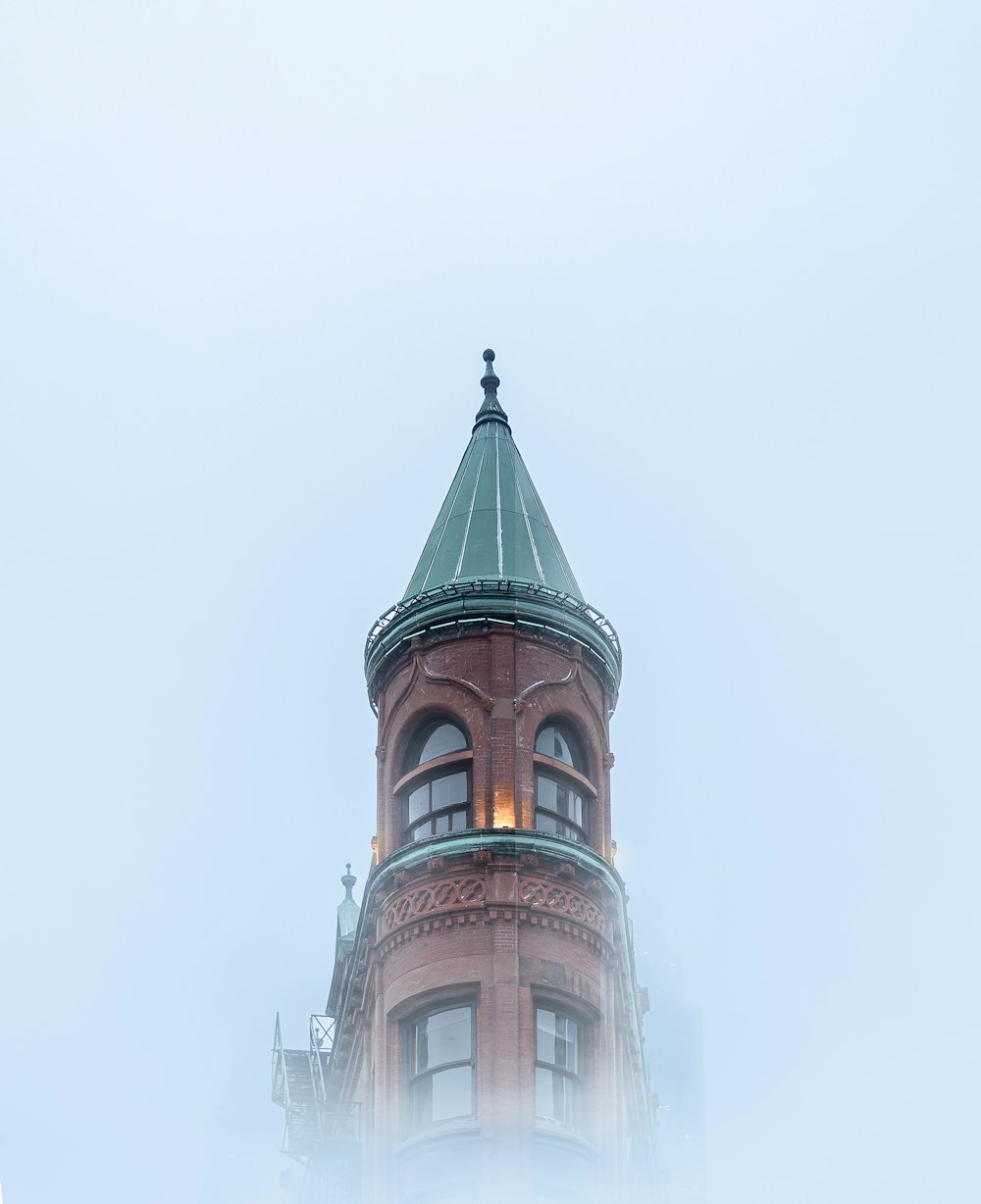 a tall tower with a clock on the top of it