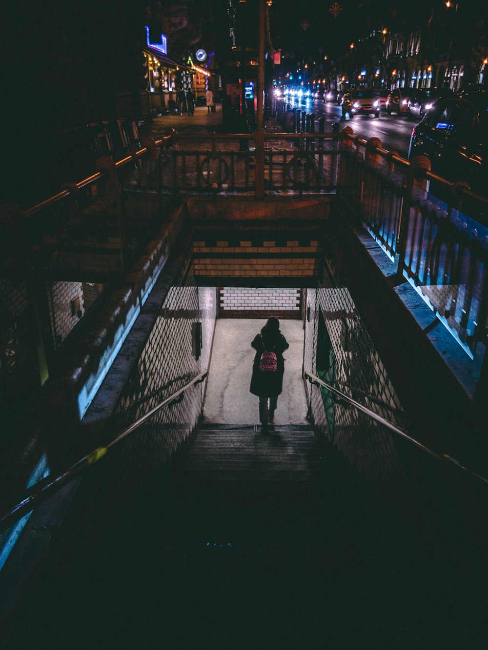 a bridge over a body of water with a city in the night sky