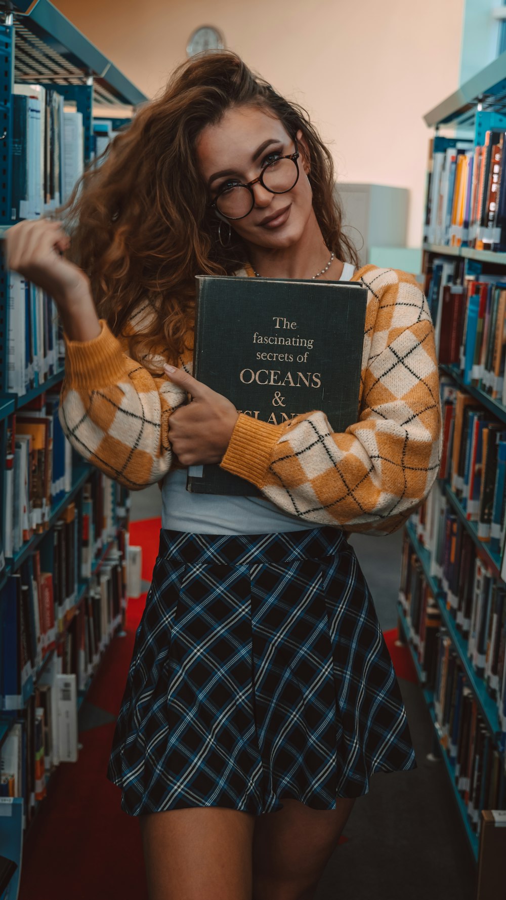 a woman holding a book in a library