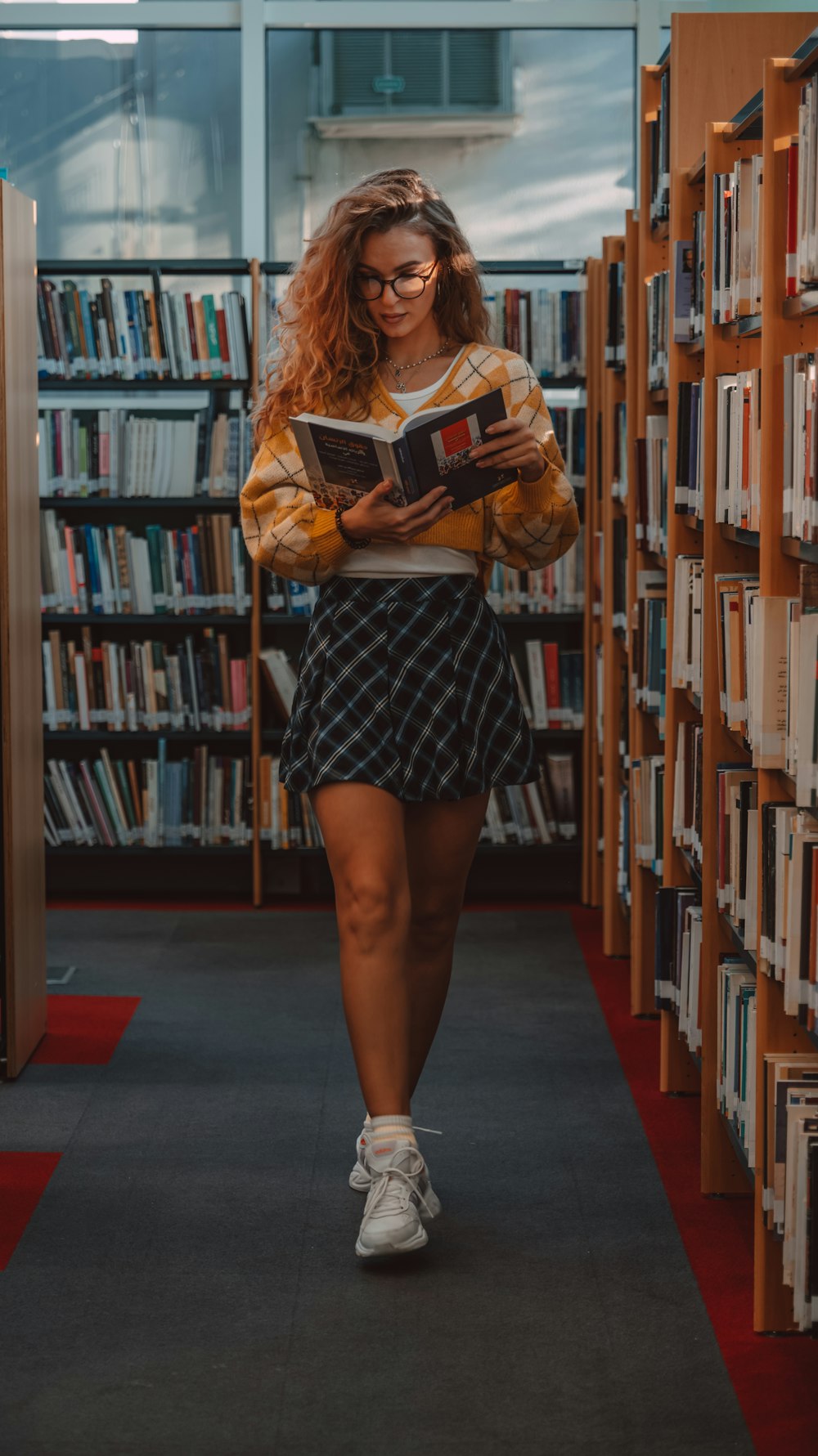 a woman in a library reading a book