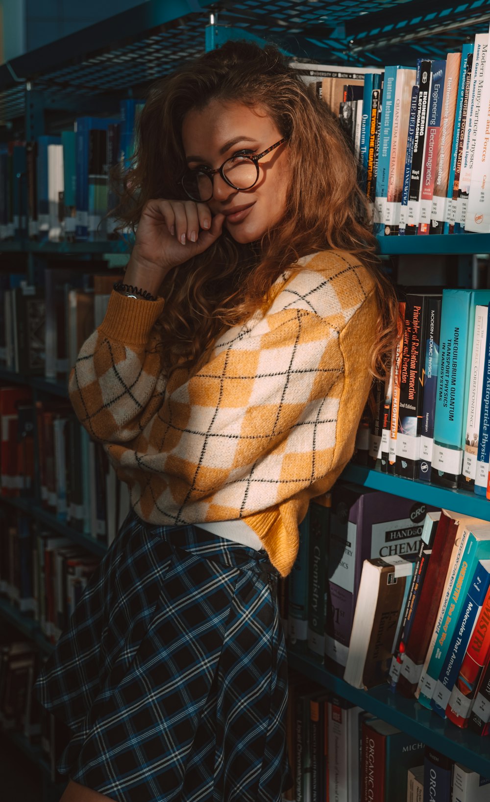 a woman leaning against a bookshelf in a library