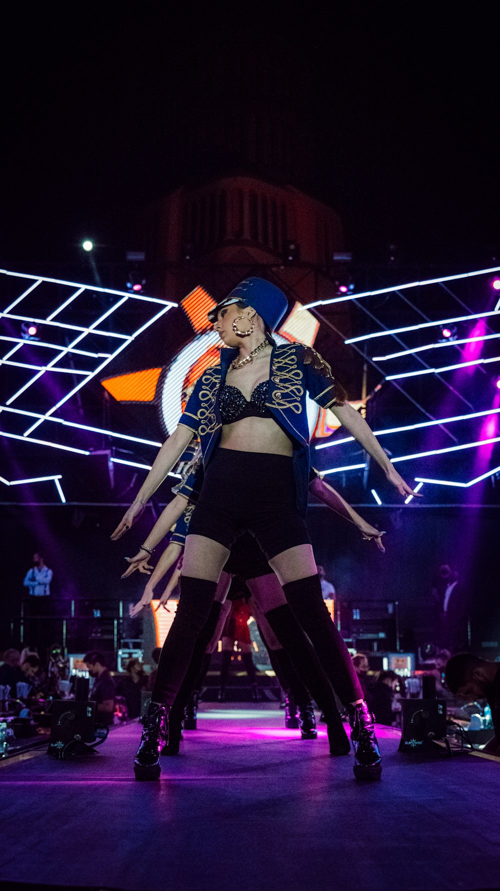 a couple of women standing on top of a stage