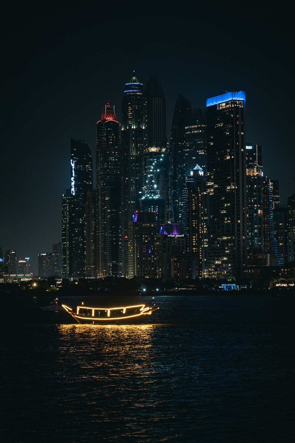 a boat in the water with a city in the background