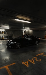a black car parked in a parking garage