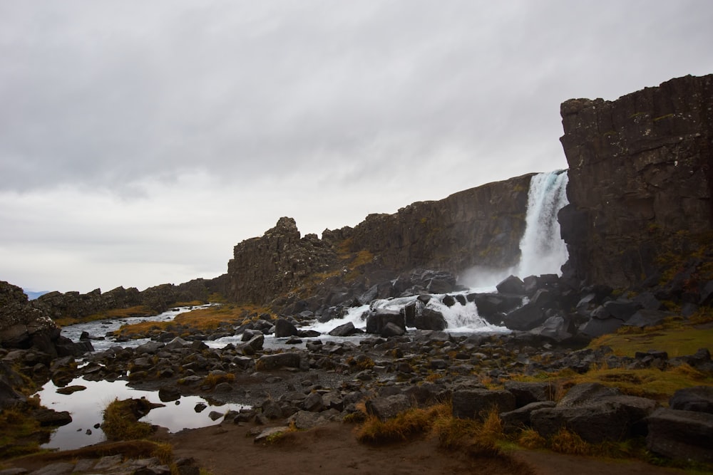 a large waterfall is coming out of the rocks