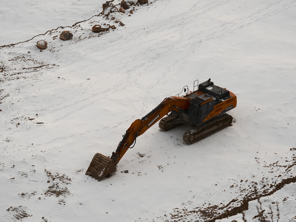 a large bulldozer digging through the snow