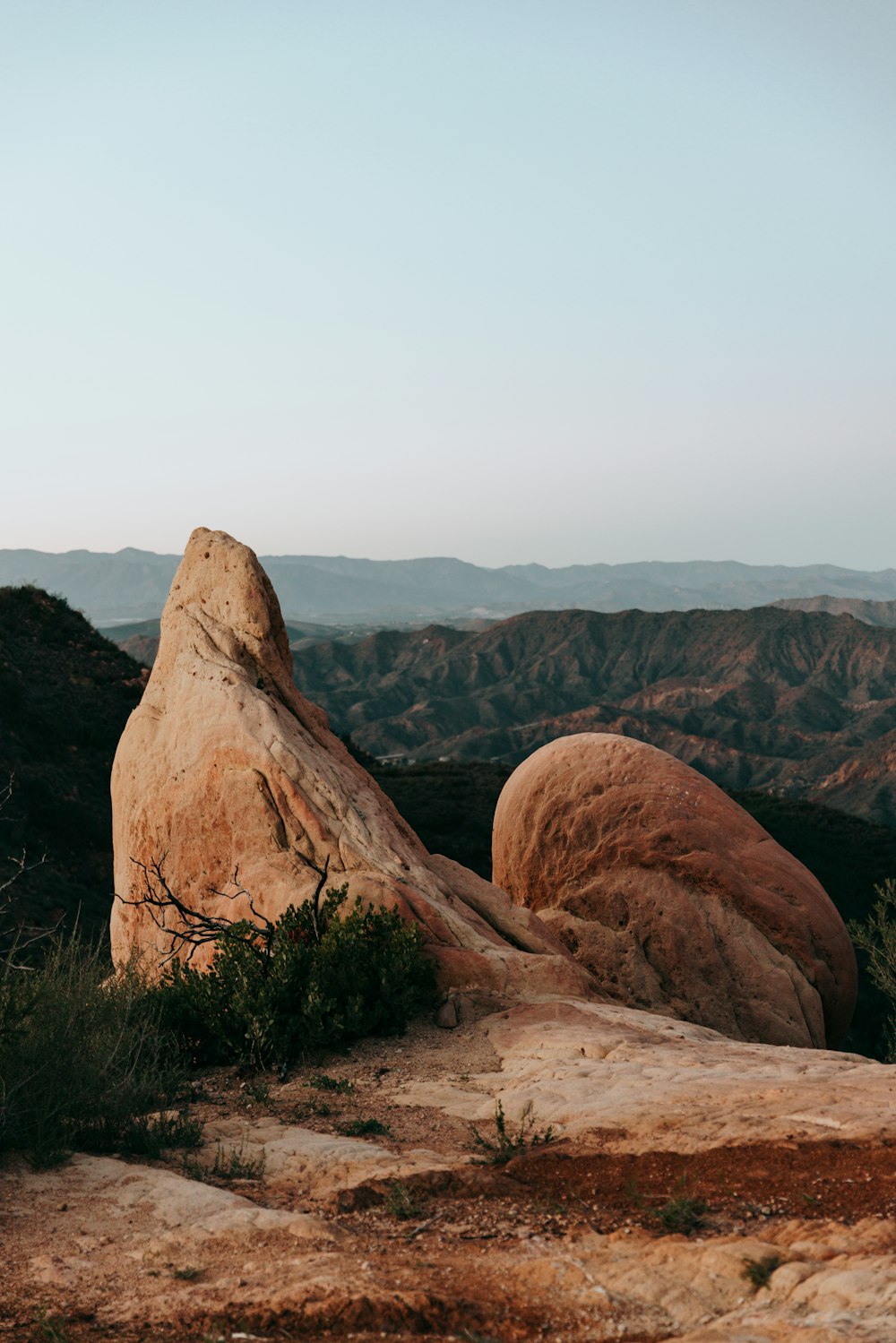 a large rock in the middle of a desert