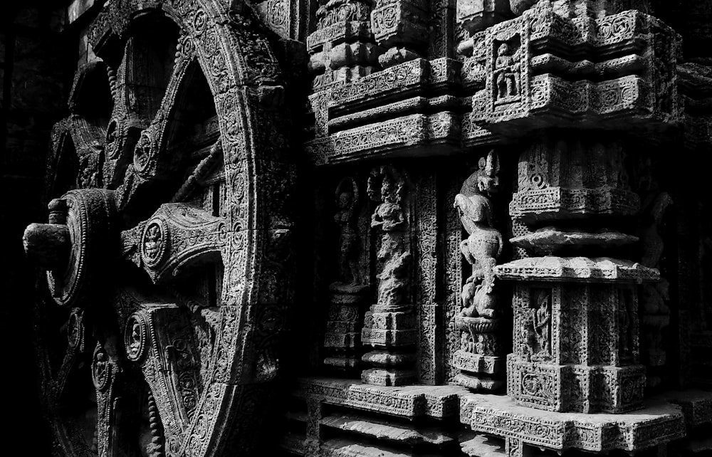 a black and white photo of a wheel on a wall