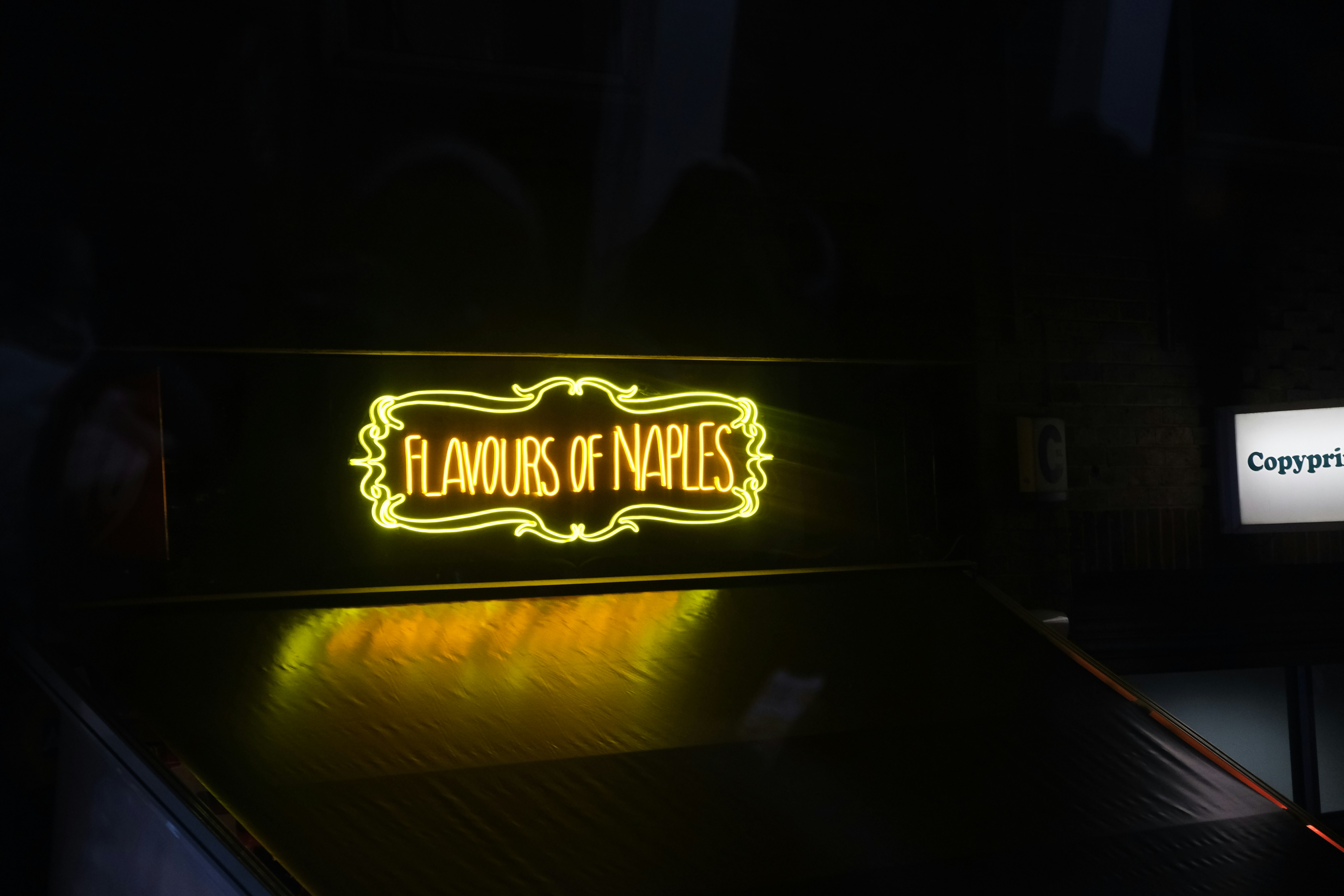 a neon sign is lit up in the dark