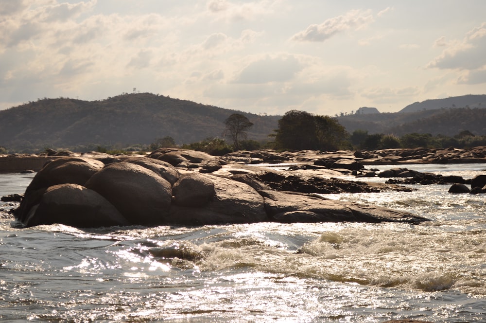 a body of water with rocks in the middle of it