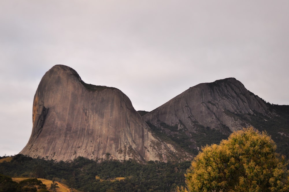 a large mountain with a very tall mountain in the background