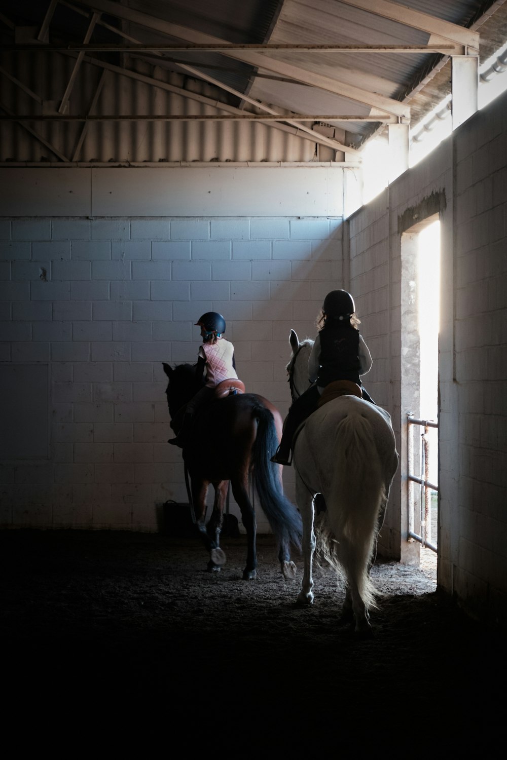 a couple of people riding on the backs of horses