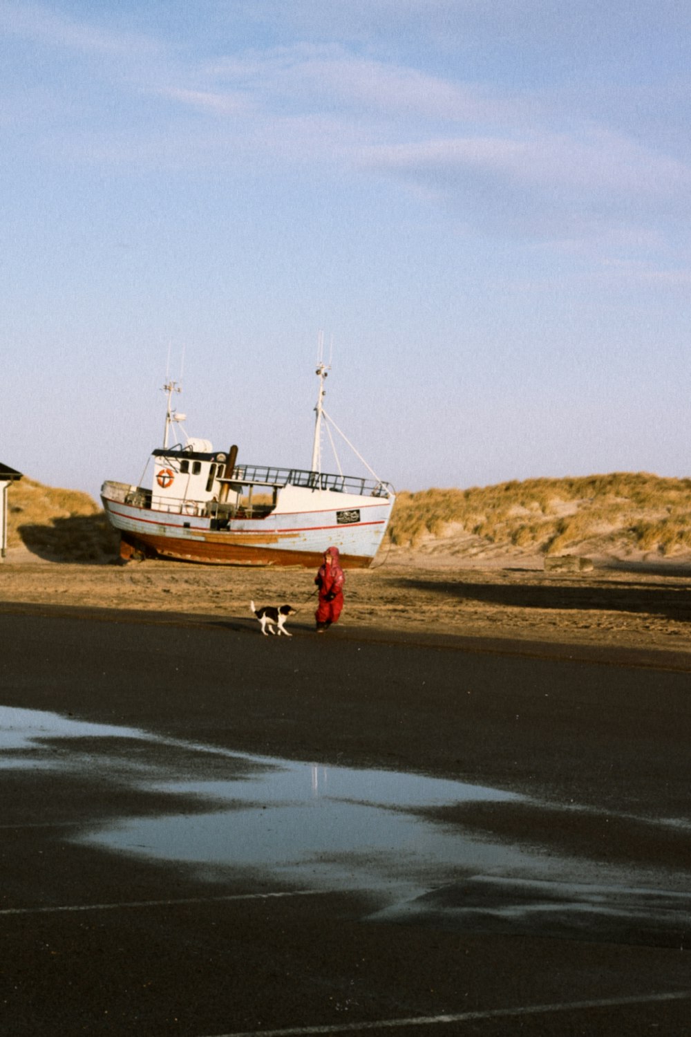 a boat sitting on top of a dry grass field