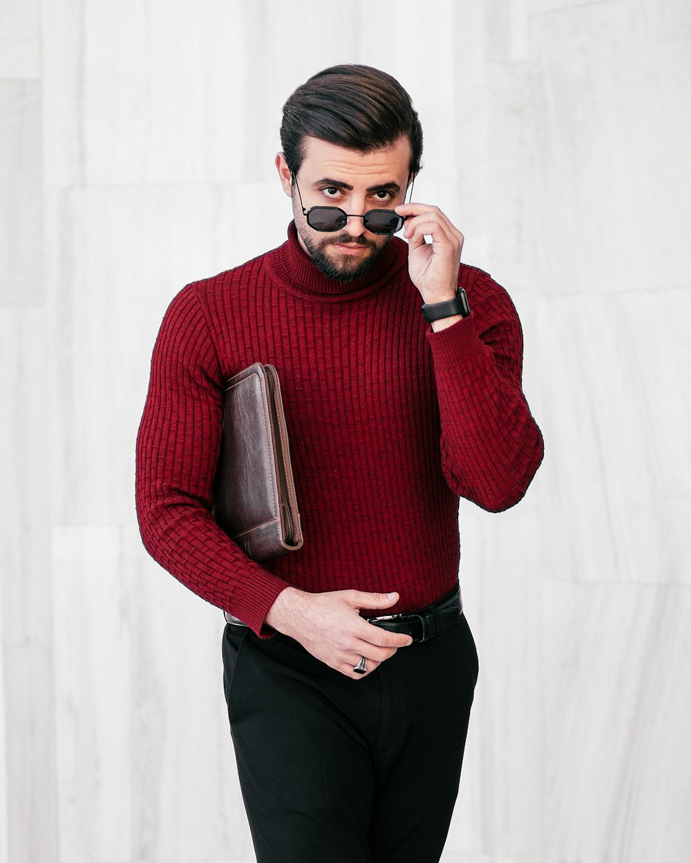 a man in a red sweater is talking on a cell phone