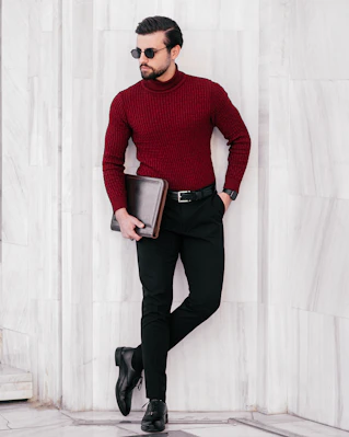 a man in a red sweater and black pants
