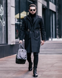 a man walking down a street carrying a bag