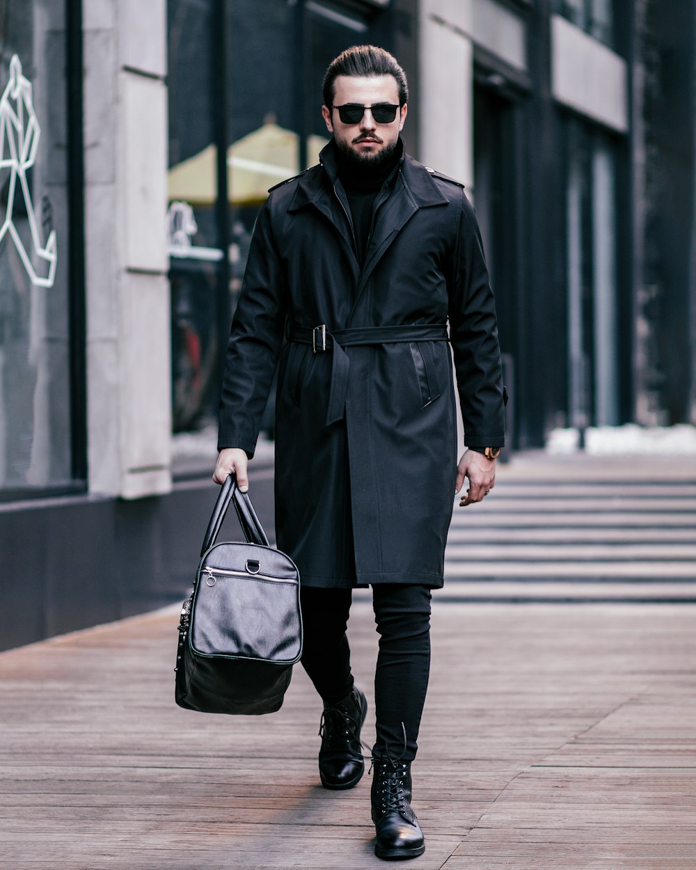 a man walking down a street carrying a bag