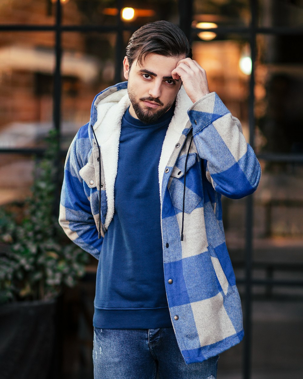 a man in a blue and white checkered jacket