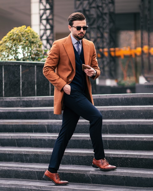 a man in a suit and tie walking down some steps