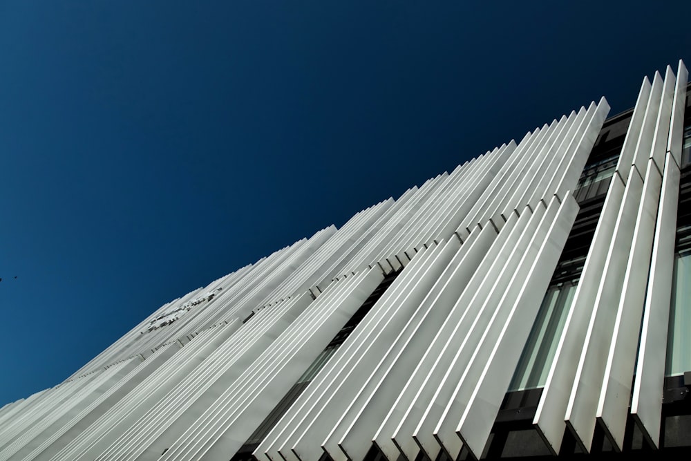 a tall white building with a blue sky in the background