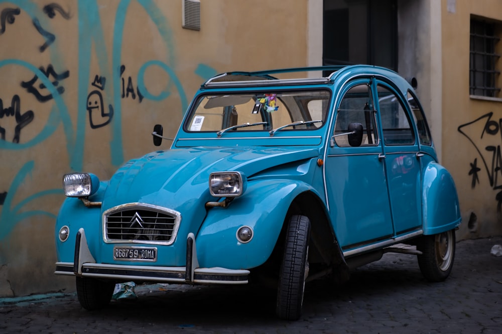 a blue car parked in front of a building