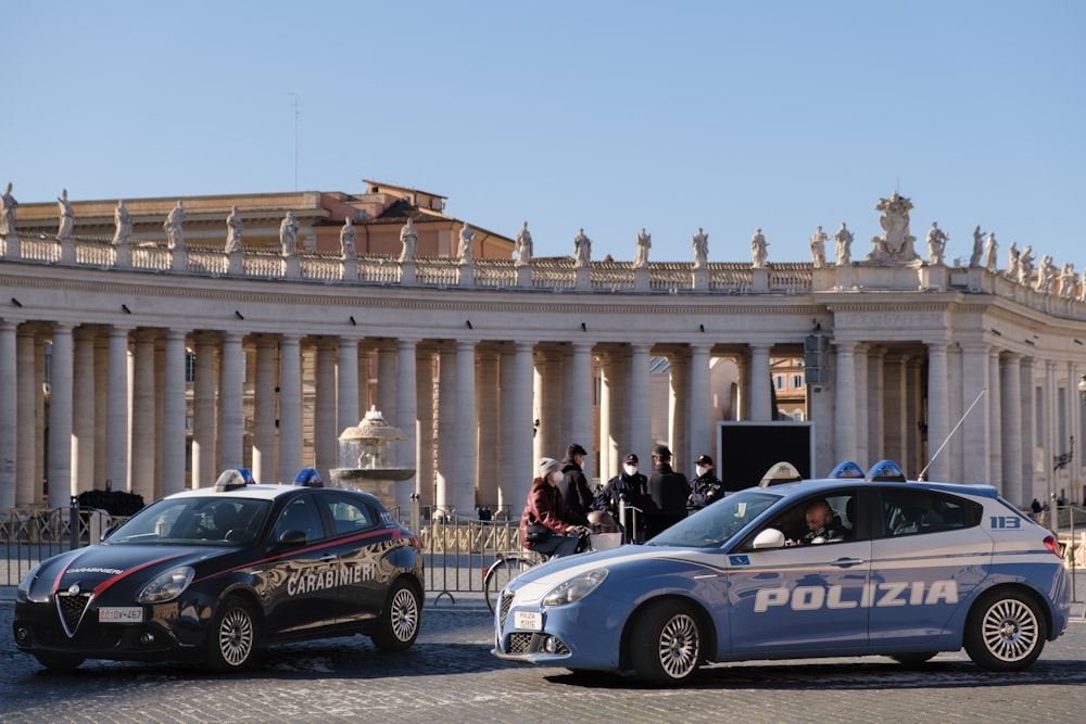 a police car and a police car parked in front of a building
