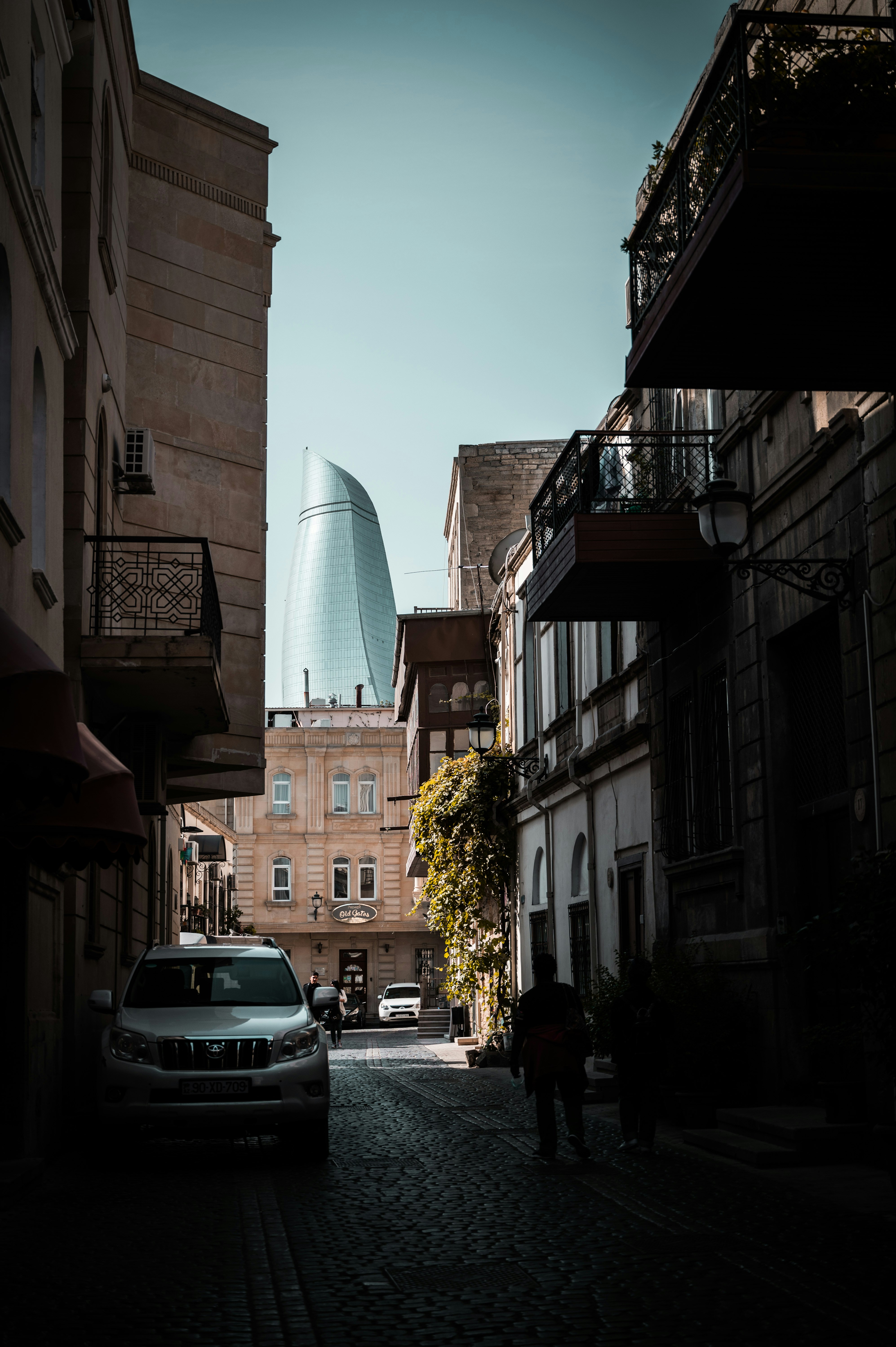 a car driving down a street next to tall buildings