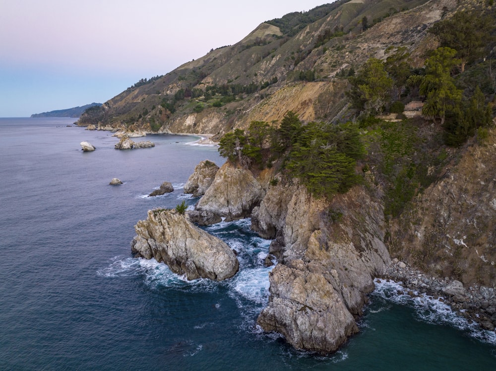 an aerial view of the ocean and cliffs