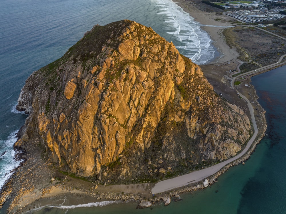 an aerial view of a large mountain near the ocean