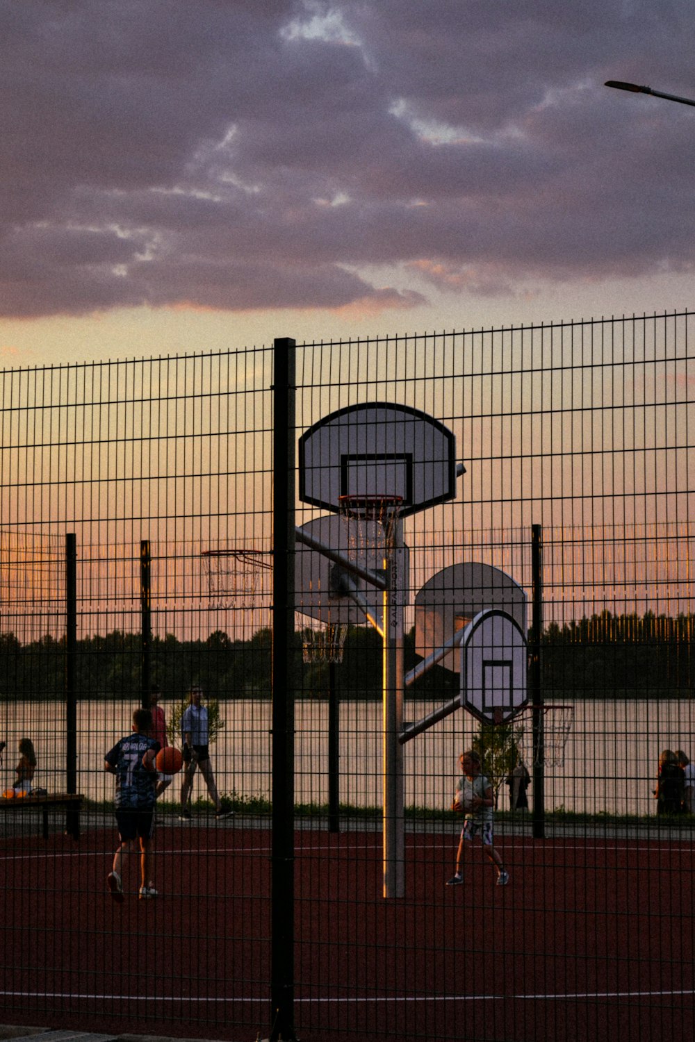 a group of people playing basketball on a basketball court
