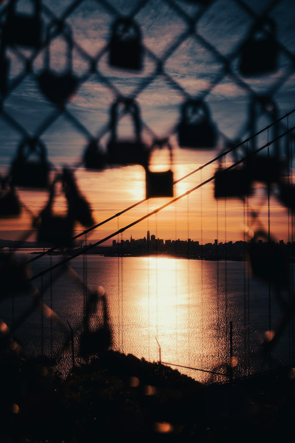 a view of a body of water through a chain link fence