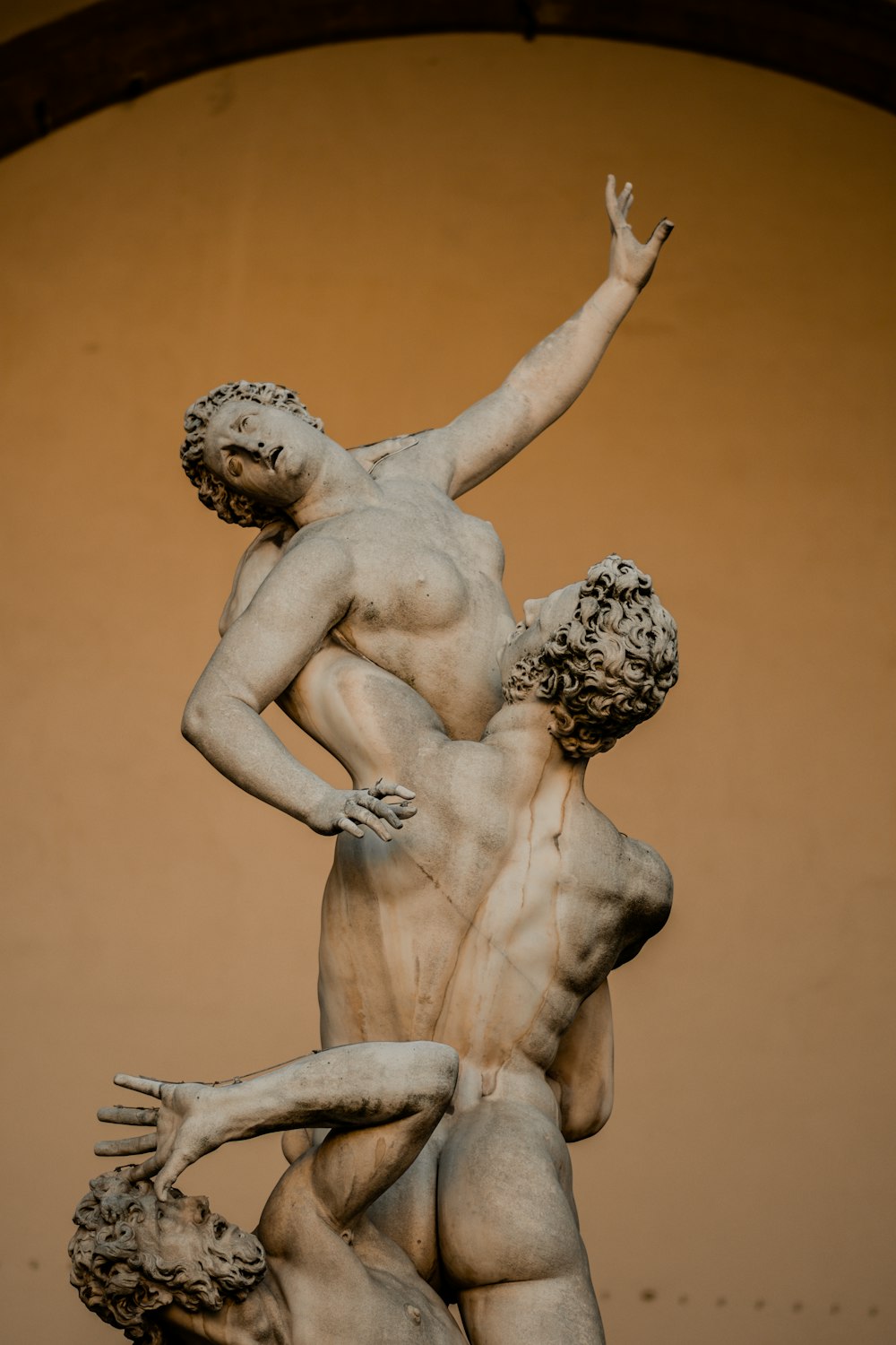 a statue of two men holding each other