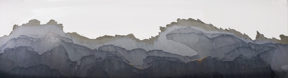 a painting of a mountain range with a sky background