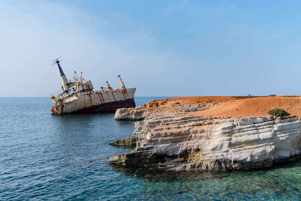 a ship sitting on top of a cliff near the ocean