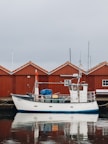 a boat is docked in front of a red building