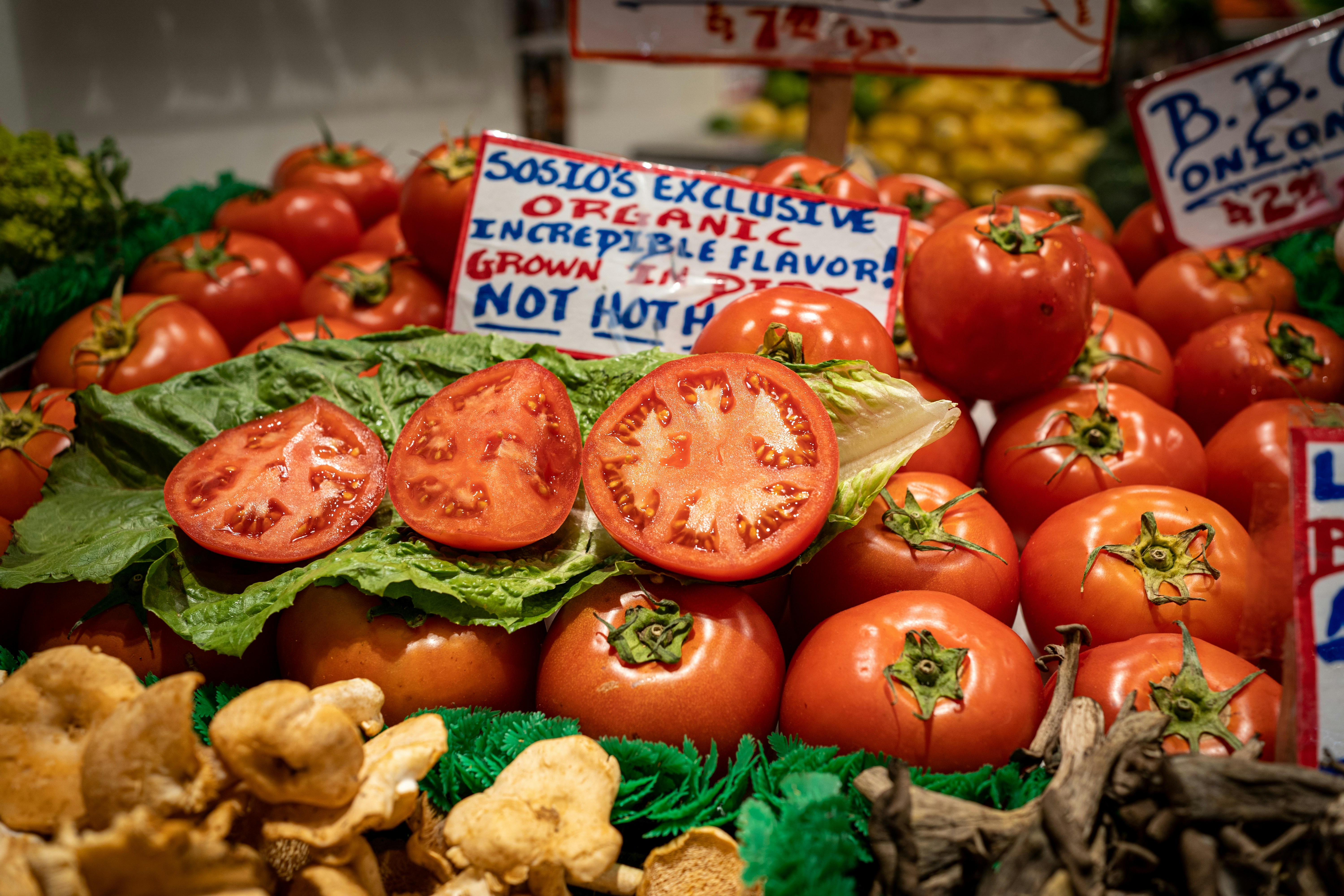 tomatoes, broccoli, and other vegetables are on display, Fresh veggies at the Pike Place Market in Seattle, Washington